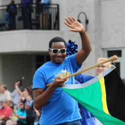 An international student walks in the Springtime Tallahassee parade for TCC's 50th Anniversary